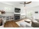 Bright living room with a herringbone fireplace, hardwood floors, and custom built-in shelving at 425 Harold Ne Ave, Atlanta, GA 30307
