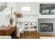 Living room featuring a fireplace with herringbone tile, built-in shelving, and hardwood floors at 425 Harold Ne Ave, Atlanta, GA 30307