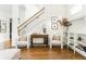 View of the living room showcasing hardwood floors, a staircase, and console table at 425 Harold Ne Ave, Atlanta, GA 30307