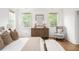 Bright main bedroom featuring hardwood floors, soft natural light, and neutral decor at 425 Harold Ne Ave, Atlanta, GA 30307