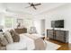 Spacious main bedroom boasts a tray ceiling, hardwood floors, and windows with bright natural light at 425 Harold Ne Ave, Atlanta, GA 30307