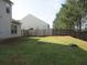 The backyard features a spacious lawn and a wood fence, offering privacy at 6069 Semaphore Rdg, Rex, GA 30273