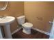 Bathroom features a pedestal sink, wood flooring, and a modern toilet at 6069 Semaphore Rdg, Rex, GA 30273