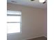 Bedroom with a large window offering plenty of natural light and neutral wall color at 6069 Semaphore Rdg, Rex, GA 30273