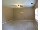 This bedroom has carpet floors, a fan, and a large window for natural light at 6069 Semaphore Rdg, Rex, GA 30273