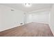 Open basement area featuring stylish wood-look flooring, modern lighting, and white painted walls at 1007 Natalie Se Ln, Smyrna, GA 30082