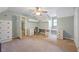 Bright bedroom featuring carpeting, a ceiling fan, built-in storage and work space, and natural light at 1007 Natalie Se Ln, Smyrna, GA 30082