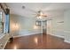 Spacious bedroom features hardwood floors, a ceiling fan, a modern light fixture, and an ensuite at 1007 Natalie Se Ln, Smyrna, GA 30082