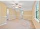 Bedroom features neutral carpeting, a ceiling fan, natural light, and a connecting door to another room at 1007 Natalie Se Ln, Smyrna, GA 30082