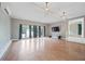 Bright living room with wood floors, modern lighting, large windows, and easy access to the staircase at 1007 Natalie Se Ln, Smyrna, GA 30082
