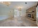 Spacious living room featuring a stone fireplace, tile flooring, and ample natural light at 1007 Natalie Se Ln, Smyrna, GA 30082