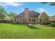 Large backyard with a patio, brick exterior, and well-kept lawn at 1593 Fredricksberg Dr, Loganville, GA 30052