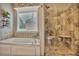 Bright bathroom with jacuzzi tub and glass-enclosed shower at 1593 Fredricksberg Dr, Loganville, GA 30052