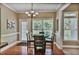 Bright breakfast nook features hardwood floors, a round table, and views of the landscaped backyard at 1593 Fredricksberg Dr, Loganville, GA 30052