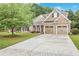 Charming home featuring a well-manicured lawn, brick and stone accents, and a spacious two-car garage at 1593 Fredricksberg Dr, Loganville, GA 30052