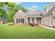 Beautiful exterior of a brick home with a well-maintained lawn and charming front porch with decorative chairs at 1593 Fredricksberg Dr, Loganville, GA 30052