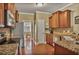Traditional kitchen with granite countertops, stainless appliances, and wood cabinets at 1593 Fredricksberg Dr, Loganville, GA 30052