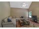 Cozy living room with a large sectional sofa, vaulted ceilings and a view of the backyard at 1593 Fredricksberg Dr, Loganville, GA 30052