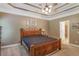 The main bedroom features trey ceilings, a ceiling fan, and ensuite bathroom at 1593 Fredricksberg Dr, Loganville, GA 30052