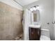 Cozy bathroom features a tile shower and flooring, updated vanity, and neutral paint at 2103 Blue Creek Ct, Conley, GA 30288