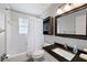 Well-lit bathroom featuring a granite vanity top, shower-tub combo, and updated fixtures at 2103 Blue Creek Ct, Conley, GA 30288