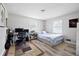 Cozy bedroom with wood floors features a work space and a comfortable bed at 2103 Blue Creek Ct, Conley, GA 30288