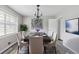 Formal dining room features modern chandelier and a large window, perfect for entertaining at 2103 Blue Creek Ct, Conley, GA 30288