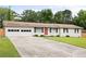 Inviting home boasting a lush green lawn, a double garage, and a vibrant red door, perfect for curb appeal at 2103 Blue Creek Ct, Conley, GA 30288