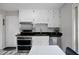 Updated kitchen with stainless steel appliances, white cabinets and eat in breakfast area at 2103 Blue Creek Ct, Conley, GA 30288
