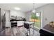 Updated kitchen with stainless steel appliances, white cabinetry, and a cozy breakfast nook with backyard view at 2103 Blue Creek Ct, Conley, GA 30288