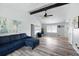 Open-concept living room featuring vaulted ceiling, modern furniture, hardwood floors, and access to a deck at 2103 Blue Creek Ct, Conley, GA 30288