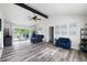 Bright living room with vaulted ceiling, exposed beam, modern furniture, and sliding door to the deck at 2103 Blue Creek Ct, Conley, GA 30288