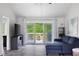 Living room with sliding glass doors to a deck, grey walls, hardwood floors and modern furnishings at 2103 Blue Creek Ct, Conley, GA 30288