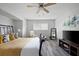 Bedroom featuring a ceiling fan, hardwood floors, and natural light from large windows at 2103 Blue Creek Ct, Conley, GA 30288