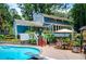 A view of the pool, back of the house, greenery and an outdoor dining area at 2910 Edwards Ct, Marietta, GA 30068