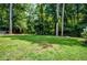 View of a large backyard with mature trees and a playset at 2910 Edwards Ct, Marietta, GA 30068