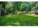 Lush green backyard offering ample space, privacy and a shed in the background with a peek of the swimming pool at 2910 Edwards Ct, Marietta, GA 30068