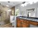 Primary bathroom featuring a glass shower, granite countertop, wood cabinets, and neutral paint at 2910 Edwards Ct, Marietta, GA 30068
