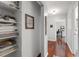 Hallway with wood floors, shelving and view of a room with a desk at 2910 Edwards Ct, Marietta, GA 30068