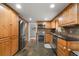 Well-lit kitchen with stainless steel appliances, granite countertops, and beautiful dark backsplash at 2910 Edwards Ct, Marietta, GA 30068