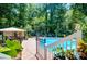 Inviting backyard pool area with ample patio space, mature landscaping, and plenty of seating and privacy at 2910 Edwards Ct, Marietta, GA 30068