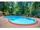 The pool and surrounding green landscaping with trees and lounge furniture at 2910 Edwards Ct, Marietta, GA 30068