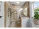Detail of glass enclosed shower with tile surround and multiple shower heads at 2910 Edwards Ct, Marietta, GA 30068