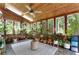 Bright sunroom with wood paneled ceiling, plenty of plants, and views of the backyard at 2910 Edwards Ct, Marietta, GA 30068