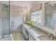 Bright bathroom featuring walk-in shower, double vanity, marble tile, and natural light at 3519 Sunderland Ne Way, Brookhaven, GA 30319