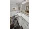 Well-lit bathroom with black marble floors, a marble countertop, and white cabinets at 3519 Sunderland Ne Way, Brookhaven, GA 30319