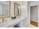 Elegant bathroom features a double vanity with gold hardware, framed mirrors, and chandelier lighting at 3519 Sunderland Ne Way, Brookhaven, GA 30319