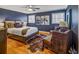 Cozy bedroom features a large bed, two sitting chairs, and hardwood floors at 3519 Sunderland Ne Way, Brookhaven, GA 30319