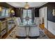 Elegant dining room with dark walls, chandelier, long dining table and 6 chairs at 3519 Sunderland Ne Way, Brookhaven, GA 30319