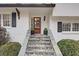 Elegant front entrance with stone steps leading to a wood door flanked by manicured shrubs at 3519 Sunderland Ne Way, Brookhaven, GA 30319